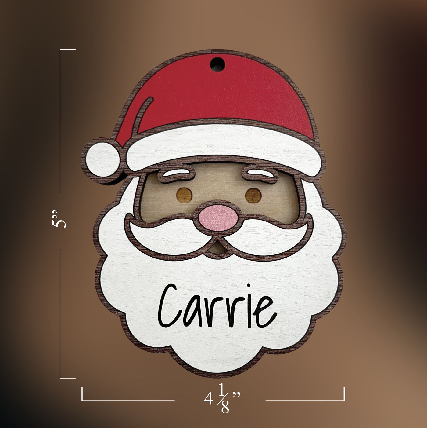 Wooden ornament shaped like a Santa Claus face with a red hat and beard, featuring the name 'Carrie'.