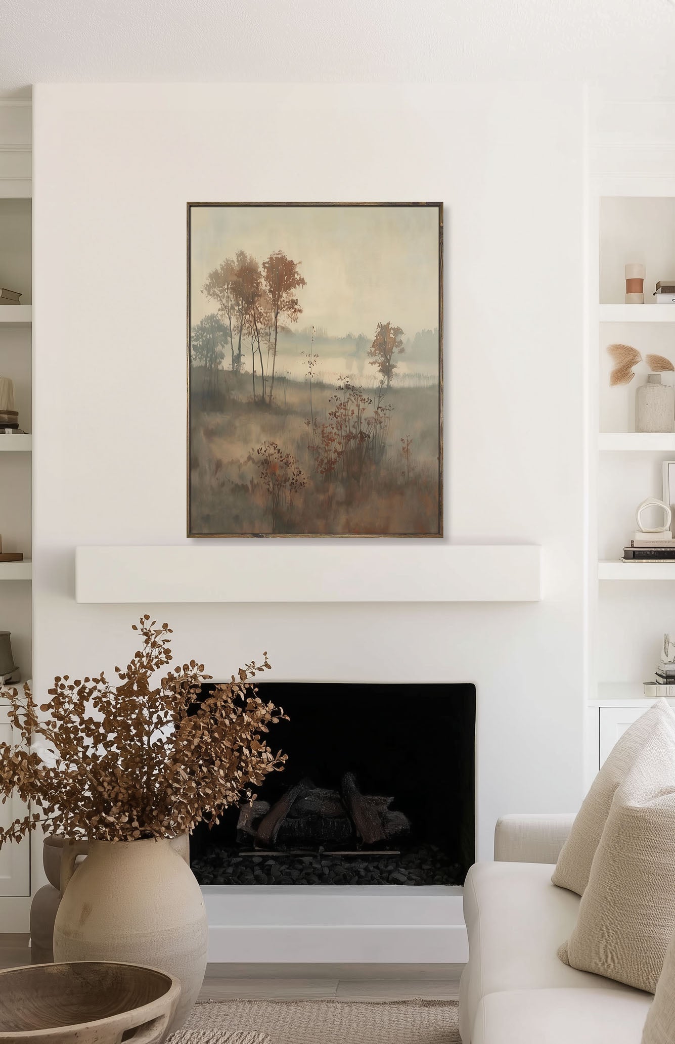 Living room with a fireplace, framed artwork, and decorative items.