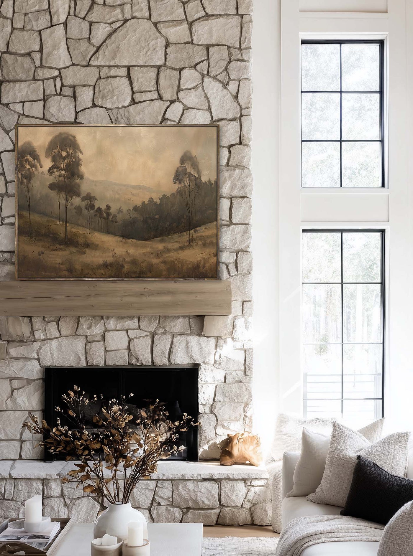Living room with stone fireplace, painting, and sofa.