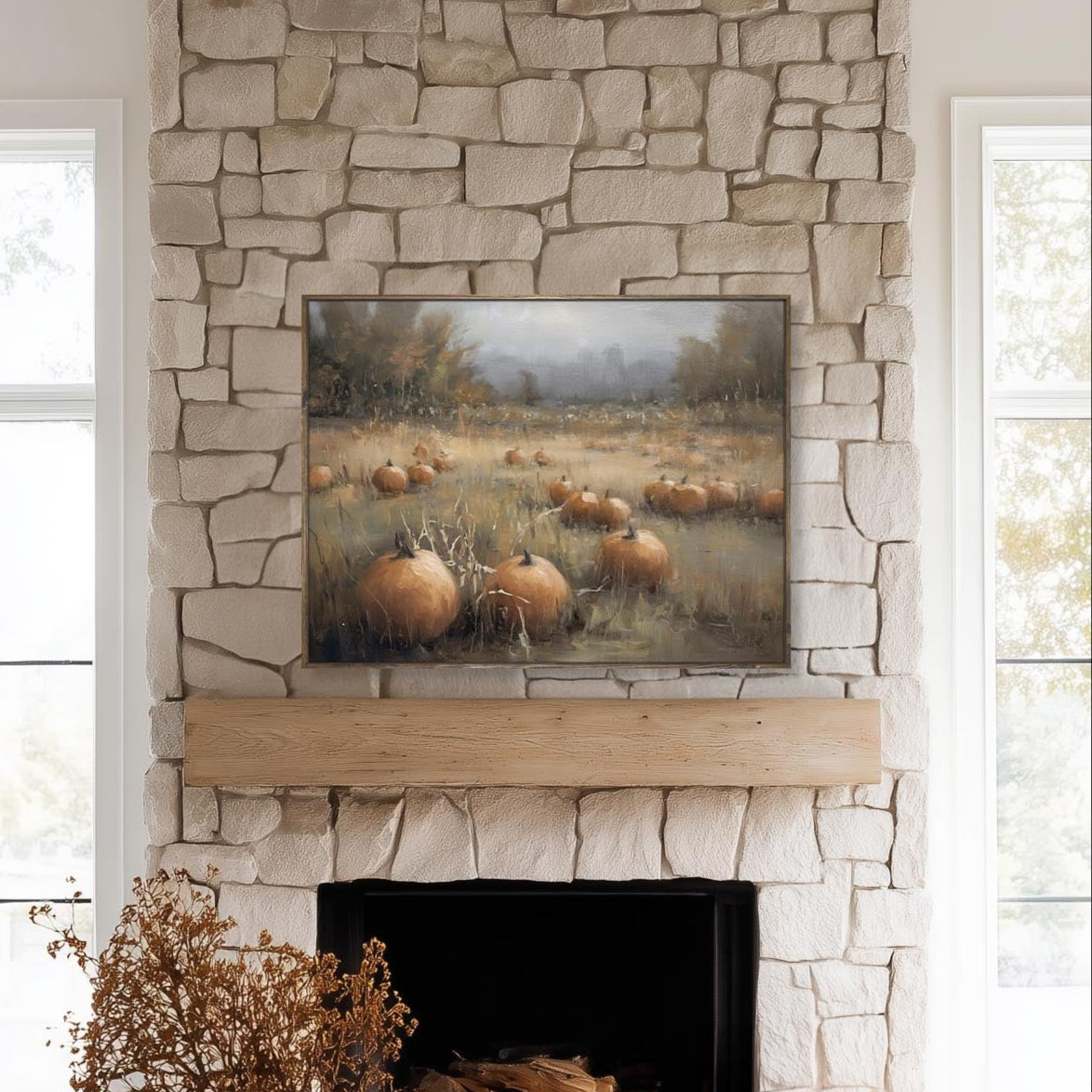 Living room with stone fireplace, pumpkin painting, and decorative items.