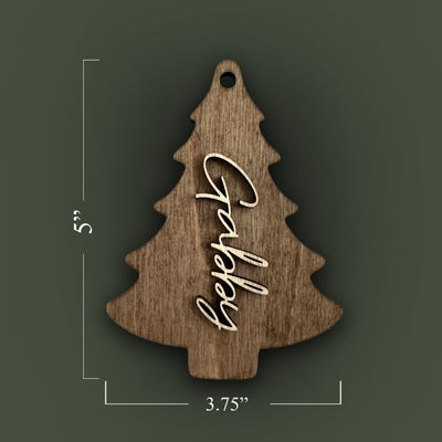 Wooden Christmas tree ornament with 'Happy' engraving and measurements on a special walnut stained background