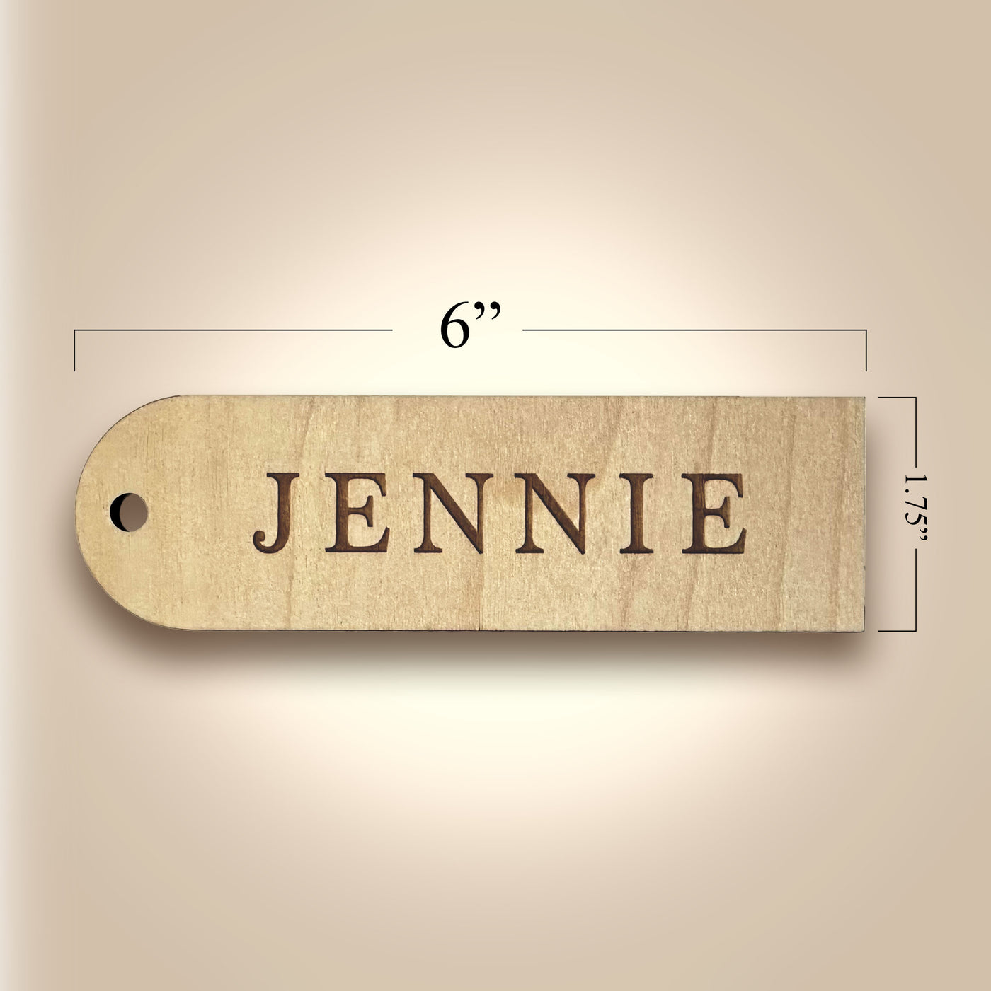 Wooden name tag with 'JENNIE' engraved, shown with dimensions on a beige background
