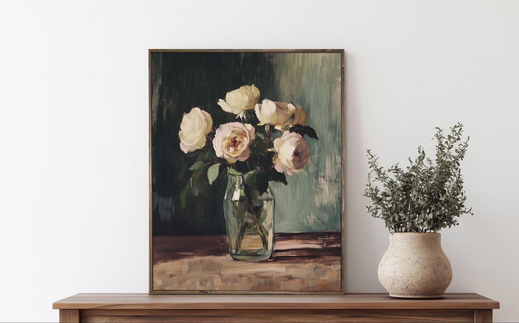 Framed painting of flowers on a wooden dresser with a vase of plants.