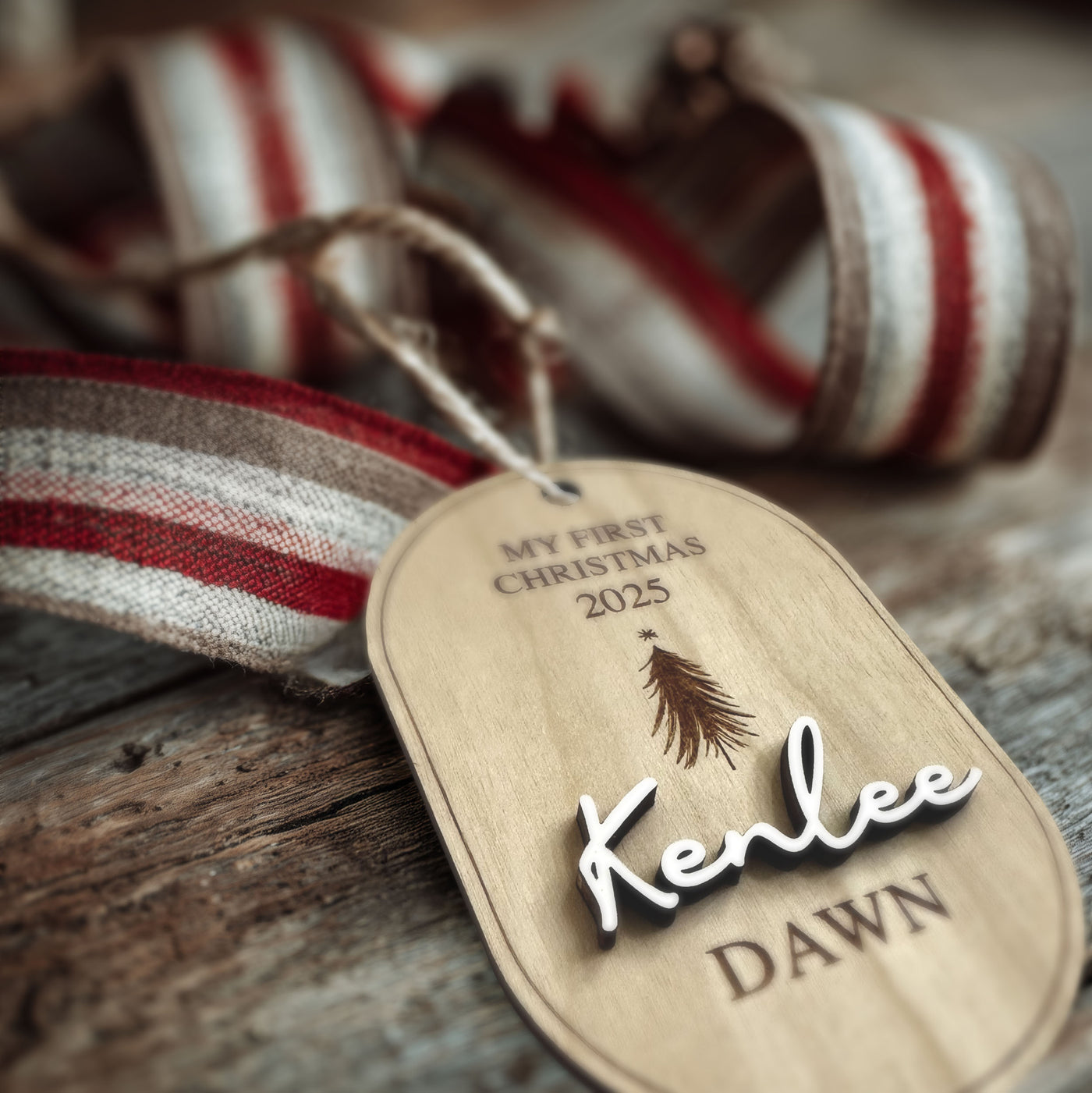 "Personalized My First Christmas wood ornament with custom baby name and year 2025, hanging on a Christmas tree."