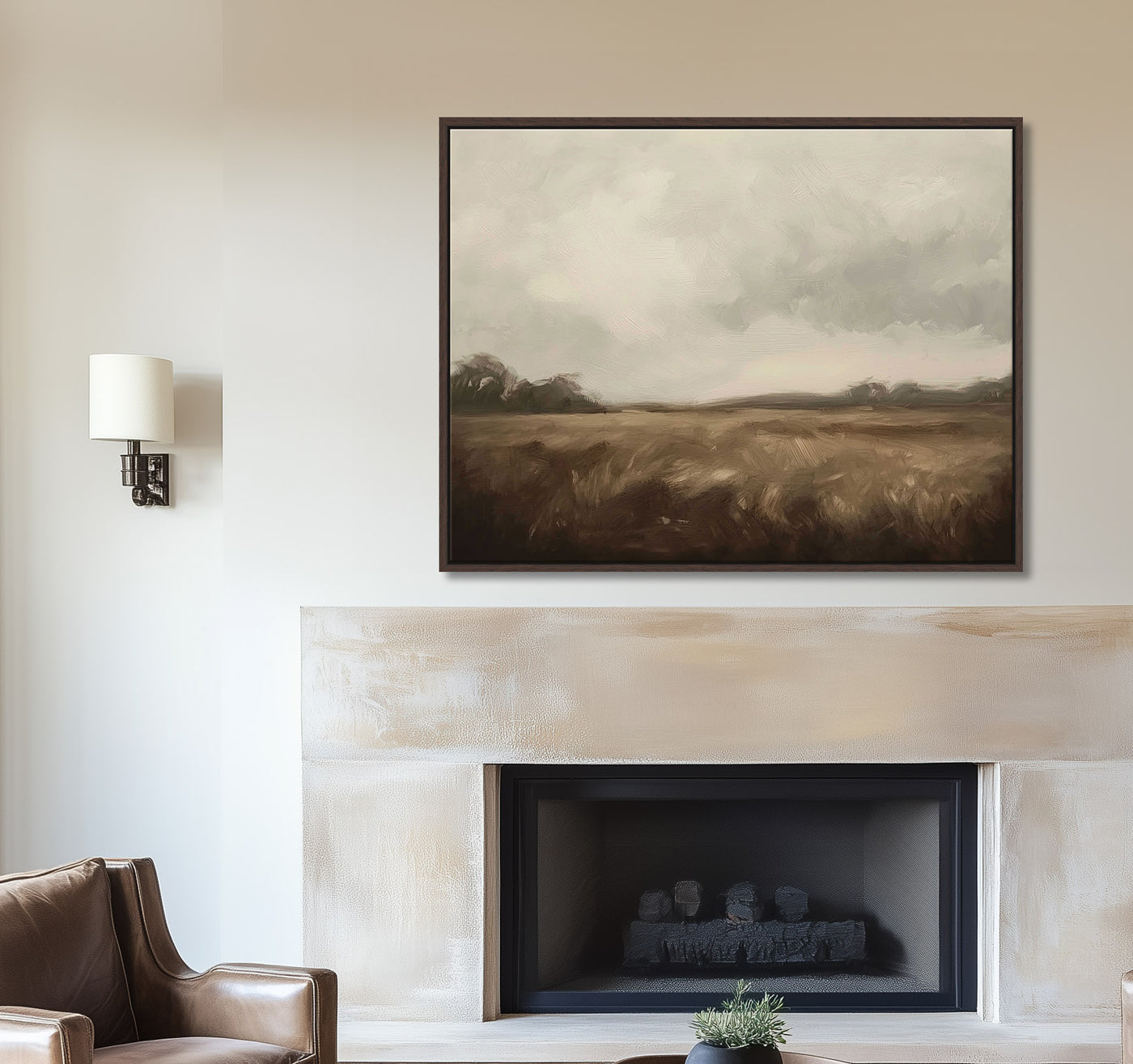Framed landscape painting above a fireplace in a living room.