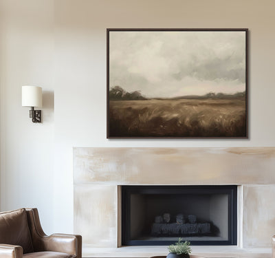 Framed landscape painting above a fireplace in a living room.