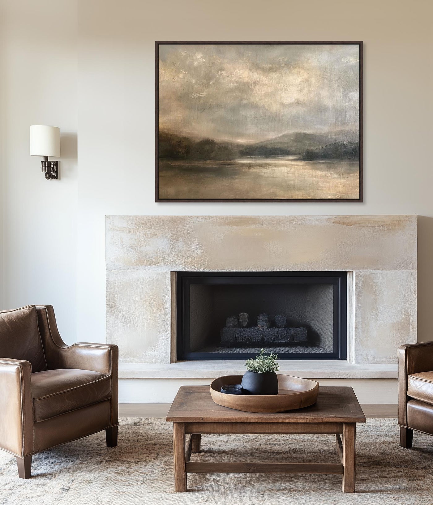 Living room with fireplace, leather chairs, and a landscape painting.
