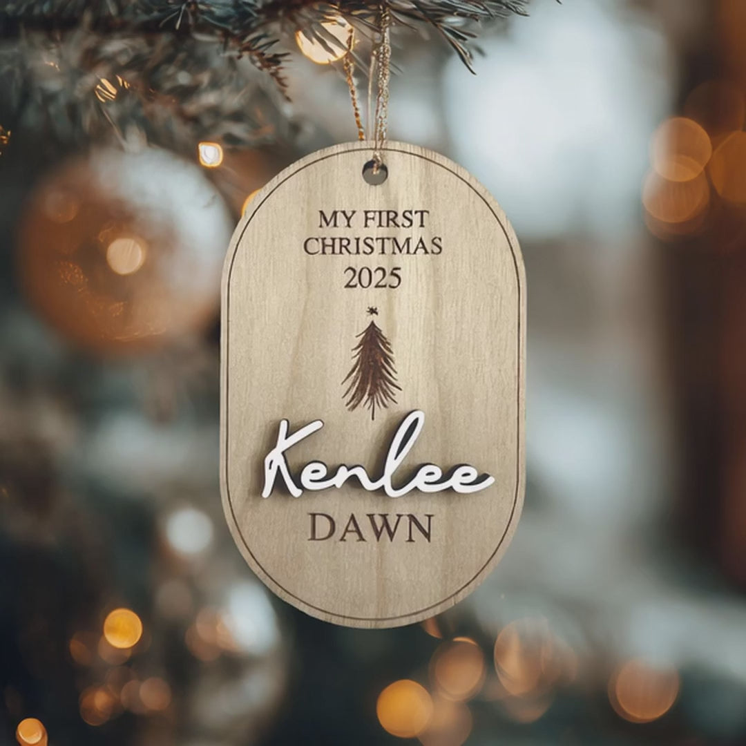 "Personalized My First Christmas wood ornament with custom baby name and year 2025, hanging on a Christmas tree."