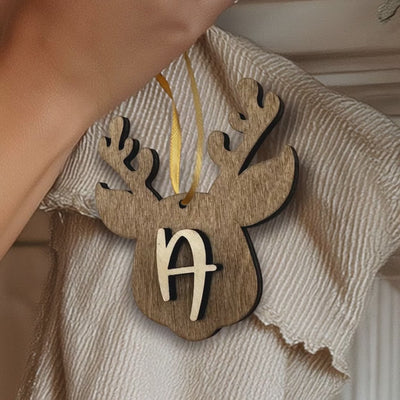 "Personalized wooden reindeer stocking tag with custom initial, hanging on a Christmas stocking with ribbon."